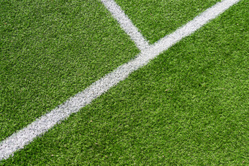 Green artificial grass turf soccer football field background with white line boundary. Top view