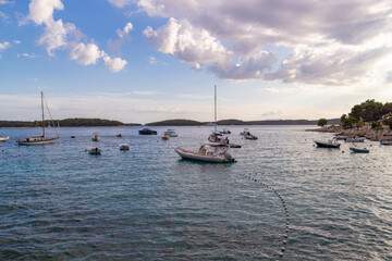 Hvar/ Croatia-August 9th, 2020: Small boats anchored in the bay off the Hvar town coast in the dying hours of the day, waving gently on the surface of blue, adriatic sea