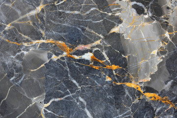 Gold yellow and white atterned structure of dark gray marble (Russia Gold) background texture for product design.