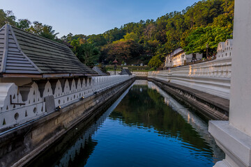 A view at sunset along the moat in front of the Temple of the Sacred Tooth Relic in  Kandy, Sri Lanka, Asia