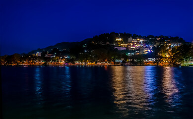 Fototapeta premium A view at night across the Sea of Milk Lake in Kandy, Sri Lanka, Asia