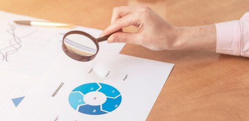 Insurance concept. female hands at office table with blue charts documents, Real Estate concept.