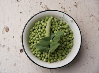 Summer harvest of green peas in a plate