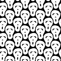 Seamless halloween vector pattern with skulls. Hand-drawn spooky carved faces. Black and white vector illustration