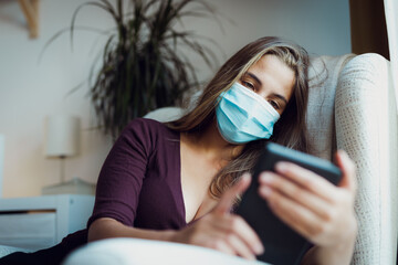 Girl Wearing mask due coronavirus reading indoors