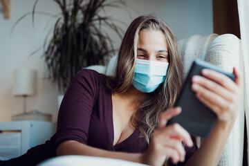 Girl Wearing mask due coronavirus while reading indoor