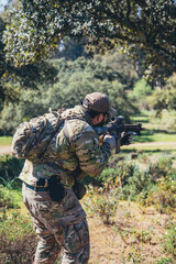 Fototapeta premium Soldier in a combat situation. Men play airsoft.