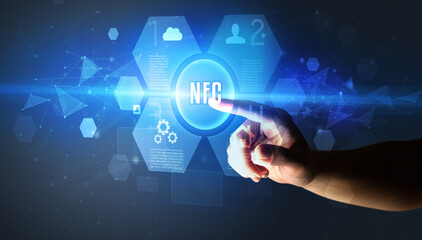 Hand touching NFC inscription, new technology concept