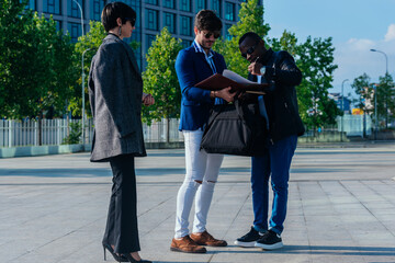 Fototapeta premium Group of successful business people discussing work outside their office building.