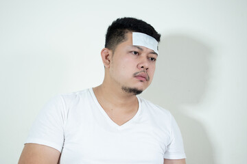 Asian men have
Antipyretic gel on the forehead
He was sick and had a fever.
Health care concept