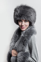 Winter fashion style. Beautiful woman in fur and jewelry. Portrait of young sexy model with beauty makeup 