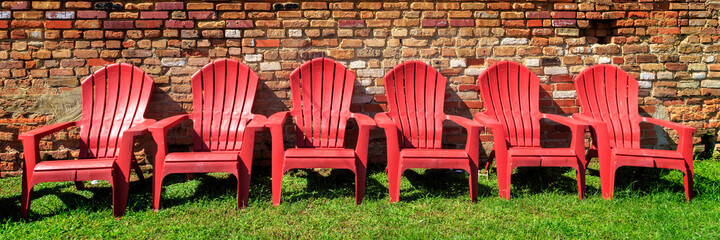Red Chairs And A Brick Wall - 377578186