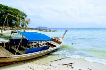 Fototapeta na wymiar Wooden fishing boat on the shore of Phi Phi island, Krabi, Thailand