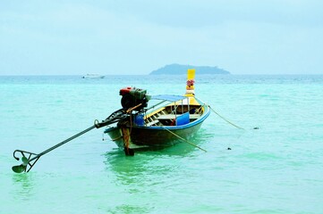 Traditional Thai wooden boat on turquoise water, Phi Phi Island, Thailand