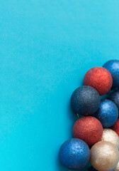 Set of multicolored Christmas balls on a blue vertical background.