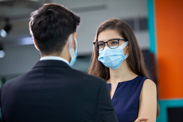 young business with face mask working in the office.