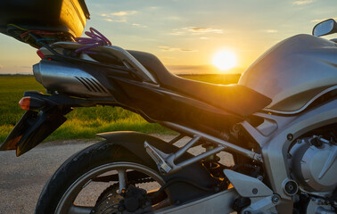 Detail of a parked road motorbike at sunset