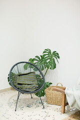 Boho interior with chair and monstera