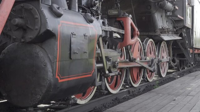 Closeup parts of old steam locomotive train wheels and rods. with original sound