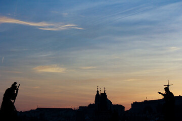 Naklejka premium Silhouette of Prague city with colorful sky and sculptures