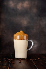 Single glass of coffee dalgona on dark rustic background