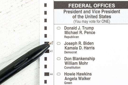 Official 2020 US Election absentee mail in ballot with a mask and a black pen focused on the presidential candidates with a shallow depth of field and copy space