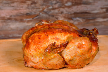 roasted chicken on wooden background