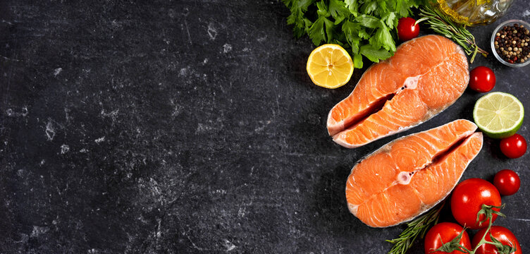 Top view of fresh raw slamon steaks with vegetables