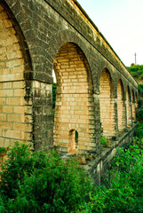 Fototapeta na wymiar aqueduct in the mountains, San Agustin del Guadalix, Spain 09-09-2020
