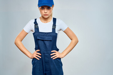 woman in work uniform blue cap service delivery service light background