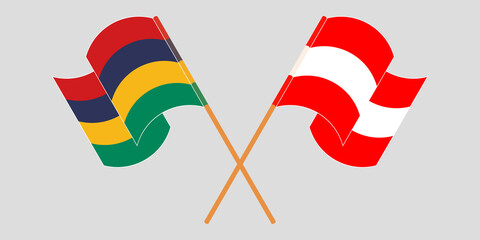 Crossed and waving flags of Mauritius and Austria