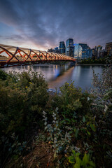 View of pedestrian bridge over the Bow River in Calgary Alberta at sunrise. 