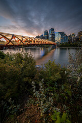 View of pedestrian bridge over the Bow River in Calgary Alberta at sunrise. 