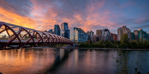 Fototapeta premium View of pedestrian bridge over the Bow River in Calgary Alberta at sunrise. 