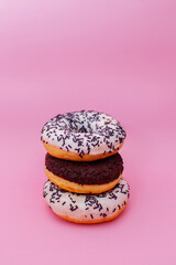 Pink sweet doughnuts on a white plate for tea, sweets