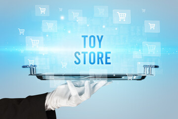 Waiter serving TOY STORE inscription, online shopping concept