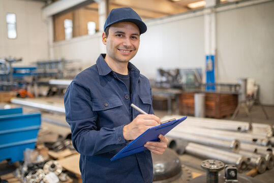 Industrial worker writing on a document