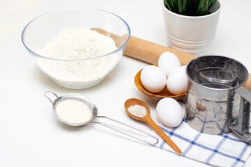 making dough for bread or homemade baked goods. ingredients on the table. against the background of a bright modern kitchen