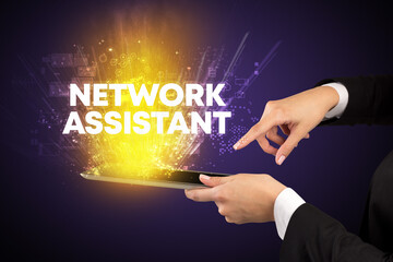 Close-up of a touchscreen with NETWORK ASSISTANT inscription, innovative technology concept