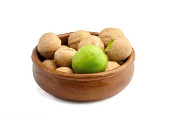 Dry walnuts in bowl isolated on white background