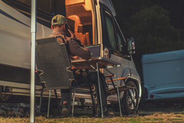 Fototapeta na wymiar Men Making Business Phone Call While Camper Camping