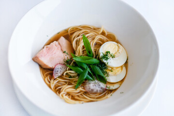 Ramen (Japanese soup with pork, egg noodles, egg, herbs and fish stock). Pretty homemade meal. Cooking and baking food while quarantining  at home during the coronavirus pandemic.