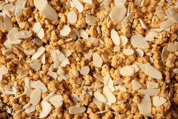 texture of baked crumble pie with fruit filling and sprinkled with grated almonds