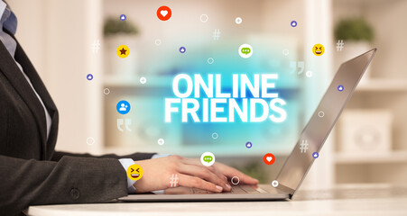 Freelance woman using laptop with ONLINE FRIENDS inscription, Social media concept