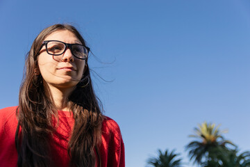young woman with blue sky copy space happy, positive concept women campaign, female social media advertising