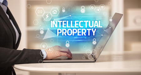 INTELLECTUAL PROPERTY inscription on laptop, internet security and data protection concept, blockchain and cybersecurity