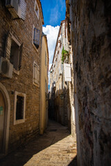 Empty narrow street of the old town of budva in montenegro on a bright sunny day
