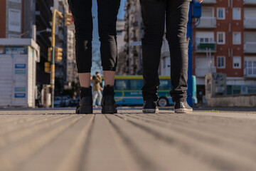 woman and men feet on the street, concept of couple, unity, city campaign, couple advertising