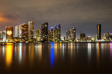 Miami skyline. Miami Florida, sunset panorama with colorful illuminated business and residential buildings and bridge on Biscayne Bay.