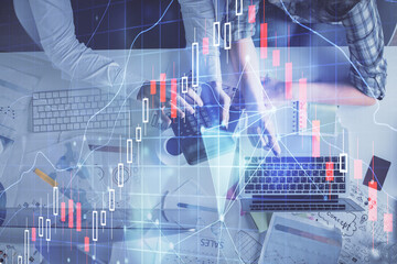 Multi exposure of man and woman working together and forex graph hologram drawing. Financial analysis concept. Computer background. Top View.